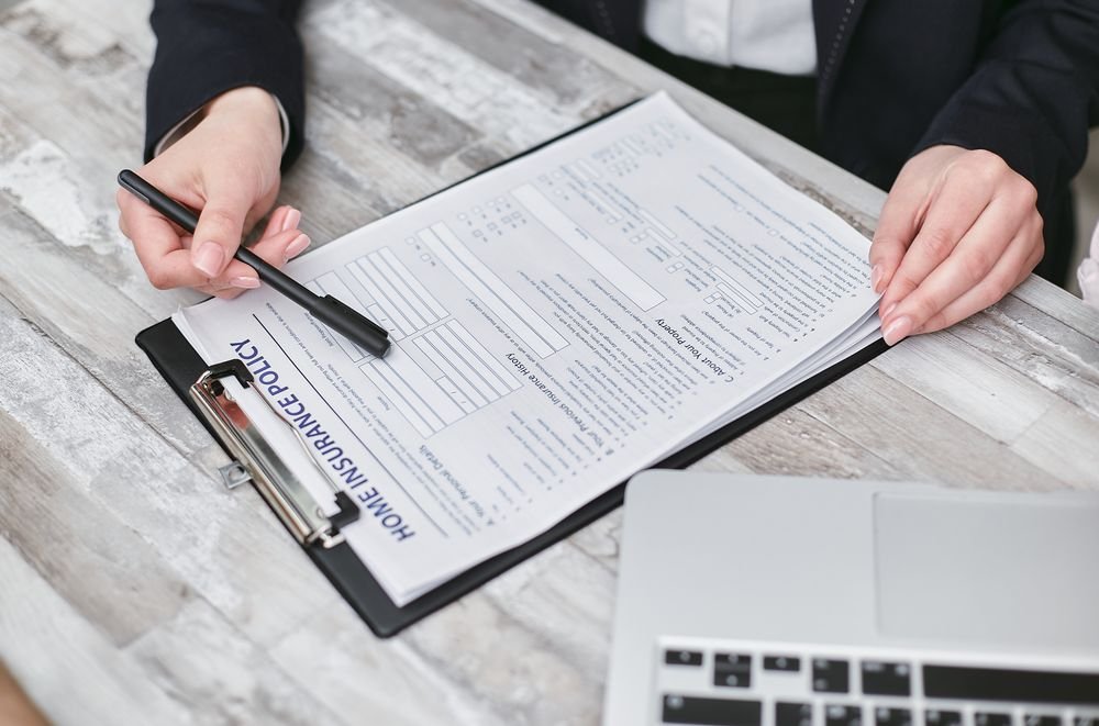 A home insurance policy being reviewed at a desk